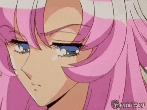 a close up of a girl 's face with pink hair and blue eyes .
