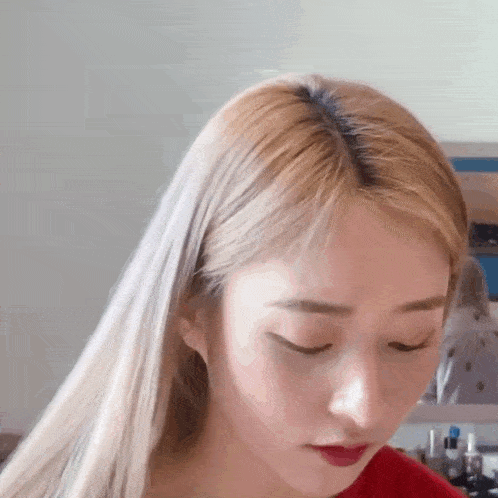 a close up of a woman with blonde hair and red lips