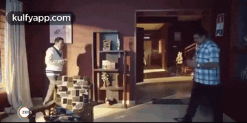 a man and a woman are standing in a living room in a house .