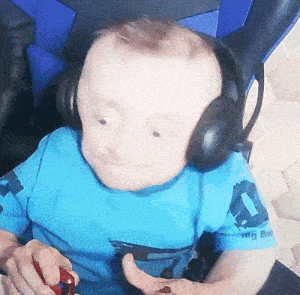 a young boy wearing headphones and a blue shirt that says big boy on it