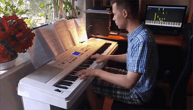 a young man is playing a keyboard with a screen that says ' l.c. ' on it