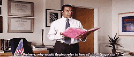 a man in a white shirt and tie is holding a pink folder and talking to mr. weinners