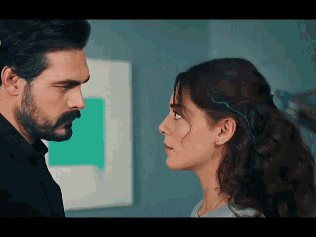 a man and a woman are looking at each other with their eyes closed