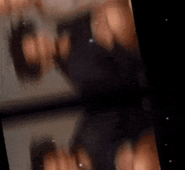 a blurred image of a person standing in a dark room
