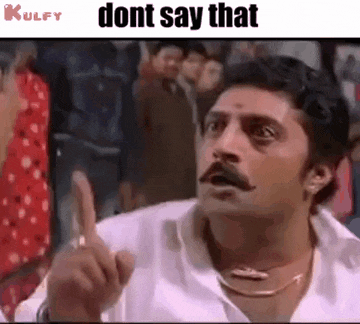 a man with a mustache is making a funny face while pointing his finger at the camera .