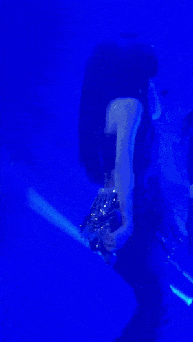 a woman singing into a microphone on a stage