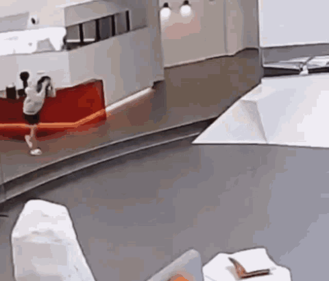 a person is standing on a conveyor belt in a room