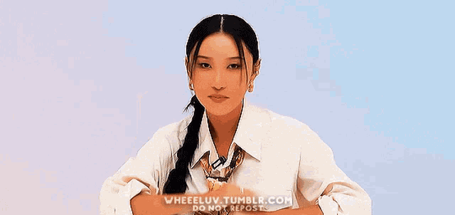 a woman with long hair is wearing a white shirt and a scarf .