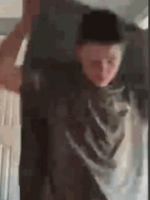 a blurry picture of a person carrying a heavy object on their back .