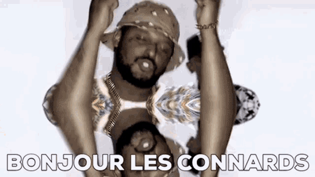 a man in a hat is dancing with his hands in the air and the words `` bonjour les connards '' .