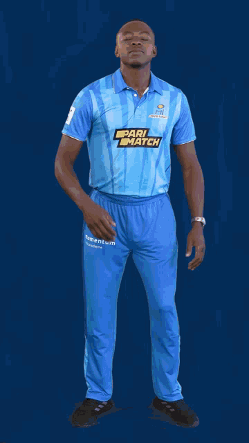 a man in a blue shirt with pari match on it