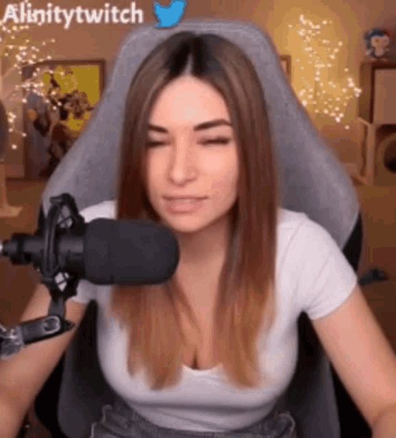a woman is sitting in front of a microphone .