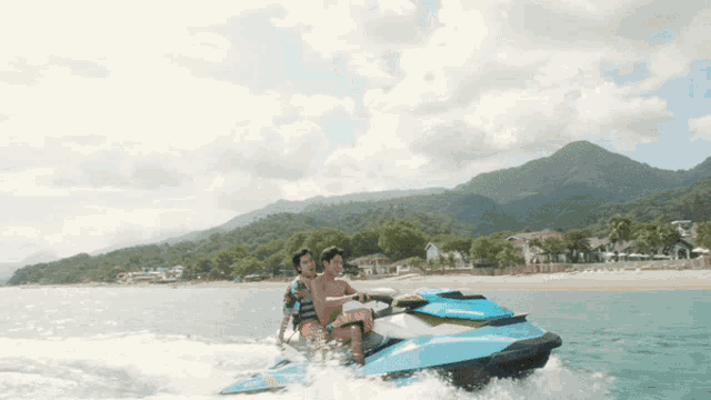 two men are riding a seadoo jet ski