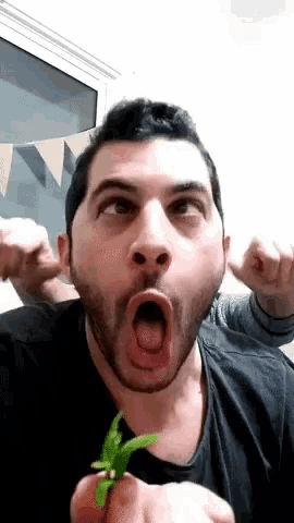 a man with a beard is making a funny face