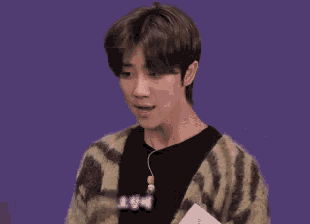 a man wearing a sweater with the number 194 on the front