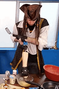 a man in a pirate costume is using a drill to drill into a piece of wood
