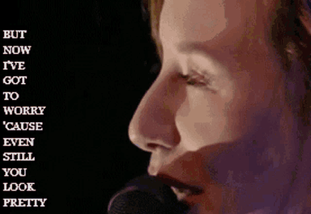 a woman singing into a microphone with the words but now i 've got to worry