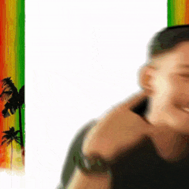 a blurry picture of a man 's face with palm trees in the background