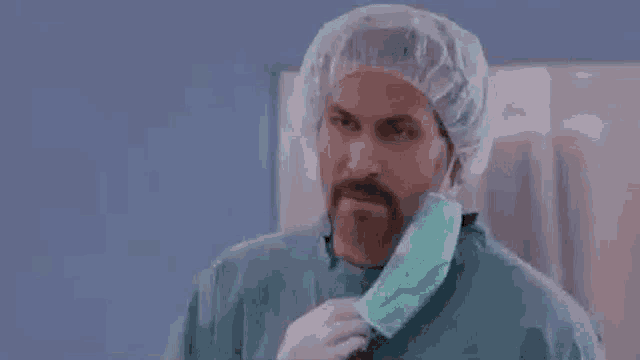 a surgeon wearing a surgical cap and mask is asking but why ?