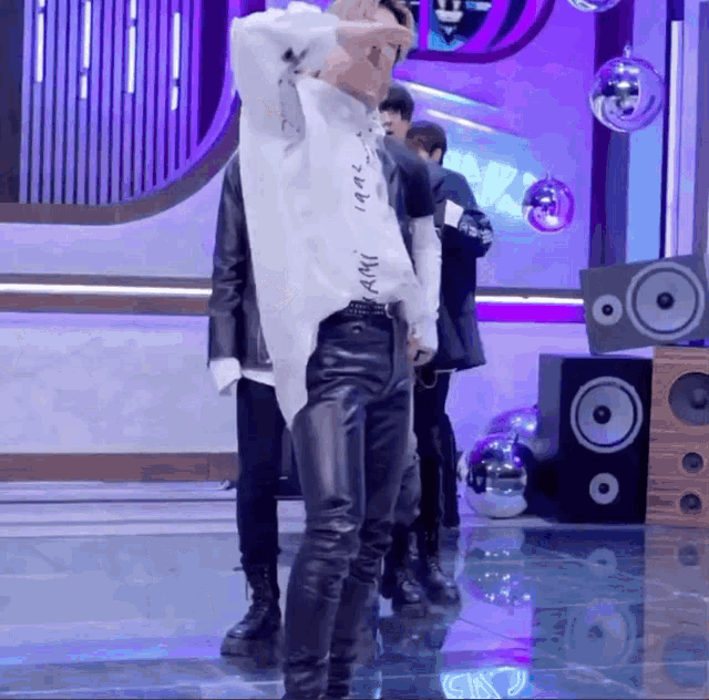 a man in a white shirt that says ' army ' on it is standing on a stage