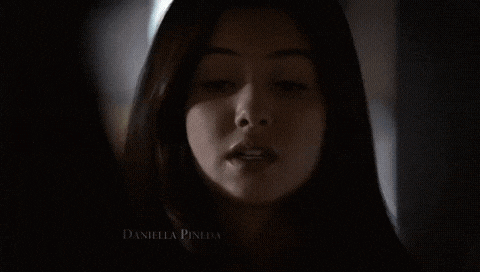 a close up of a woman 's face in a dark room .