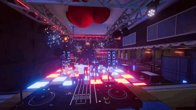 a dj is playing music in a club with a red heart hanging from the ceiling above