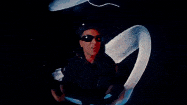 a man wearing sunglasses is flying through the air in a fisheye lens .