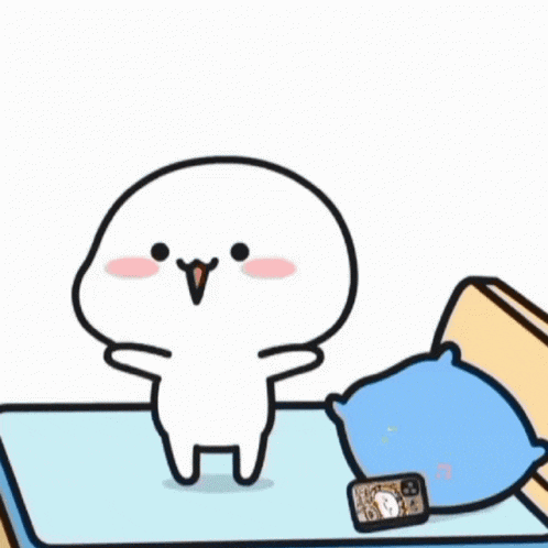 a cartoon character is sitting on a bed with a heart in his hand .