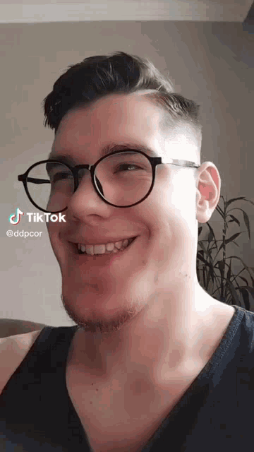 a man wearing glasses and a black shirt has a tiktok account