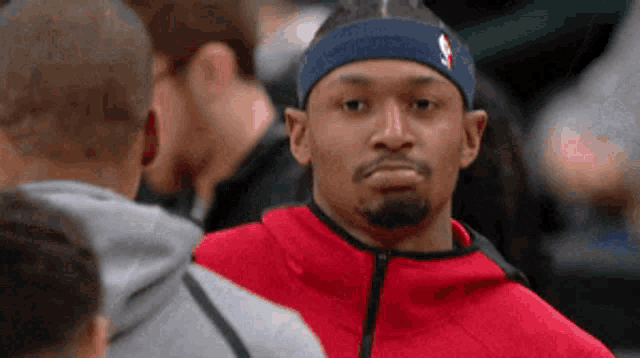a man wearing a headband with the nba logo