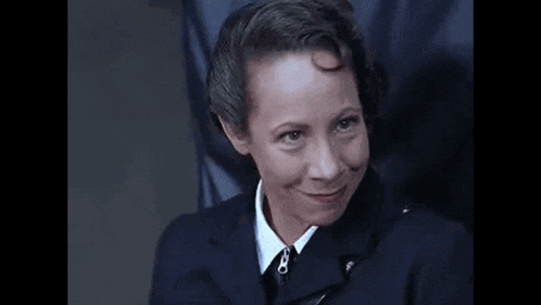 a man in a suit and tie is making a funny face and saying shannannn !!! .