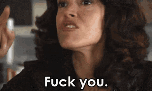 a close up of a woman 's face with the words " fuck you " written on it .