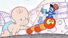 a baby in a diaper is crawling next to a worm .