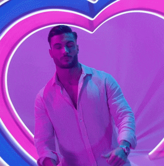 a blurry picture of a person standing in front of a heart shaped wall