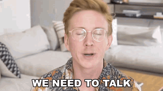 a man wearing glasses says " we need to talk "
