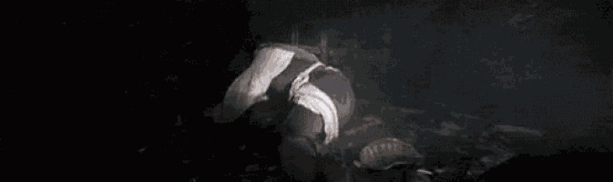 a man is laying on the ground in the dark with the words `` stop blowing holes in my ship '' written on the bottom .