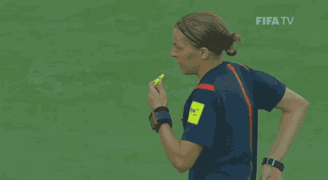 a referee is giving a red card to a player