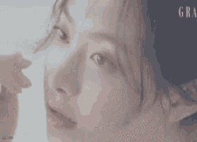 a close up of a woman 's face with the word gra visible