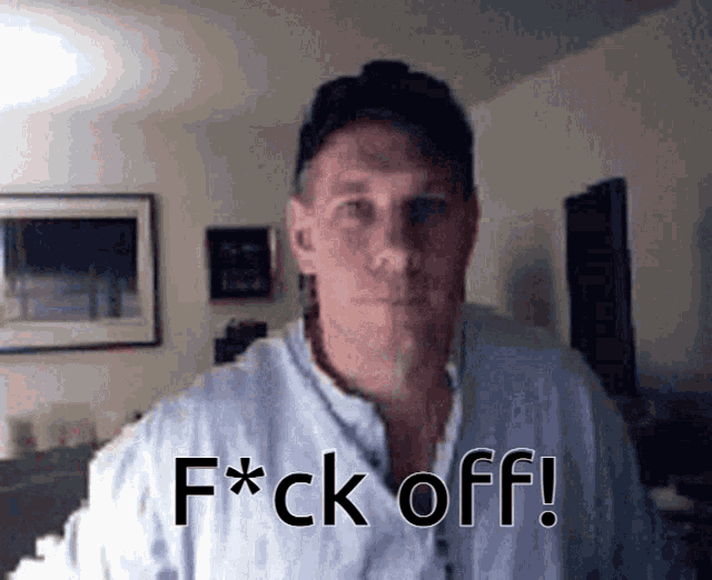 a man says f * ck off in front of a picture