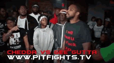 a group of men standing in front of a sign that says chedda vs gee gutta www.pitfights.tv