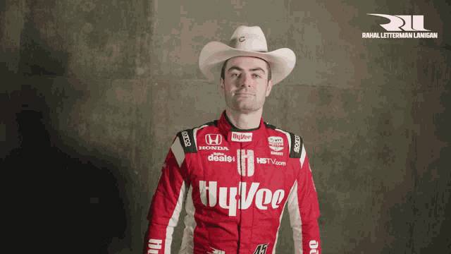 a man in a cowboy hat is wearing a red honda shirt