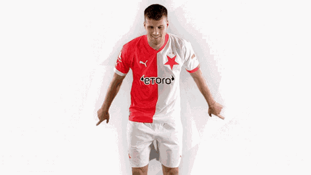 a man wearing a red and white jersey with etoro on it