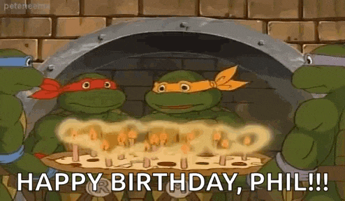 a group of teenage mutant ninja turtles are celebrating their birthday with a pizza .