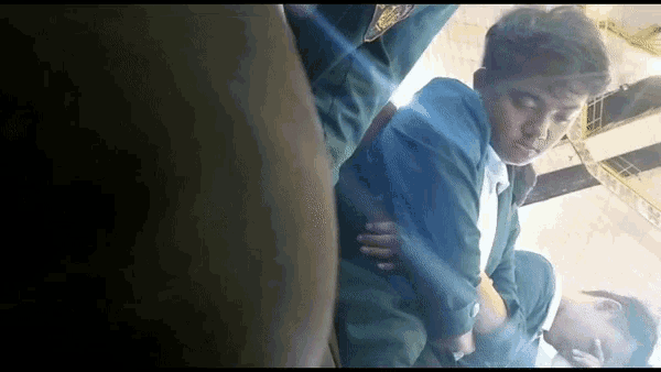 a man in a green jacket is laying on the floor with his eyes closed