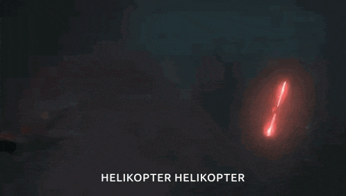 a helicopter is flying in the dark with a red light coming out of it 's tail .