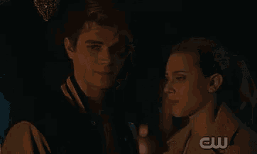 a man and a woman are looking into each other 's eyes in the dark .