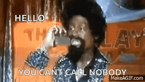 a man with a beard is talking on a telephone and says `` hello you can 't call nobody '' .