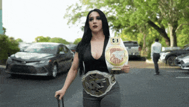 a woman wearing a nxt belt is holding a suitcase