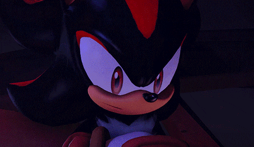 a close up of shadow the hedgehog 's face with red eyes