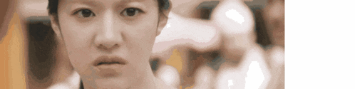 a close up of a woman 's face with a serious expression on her face .